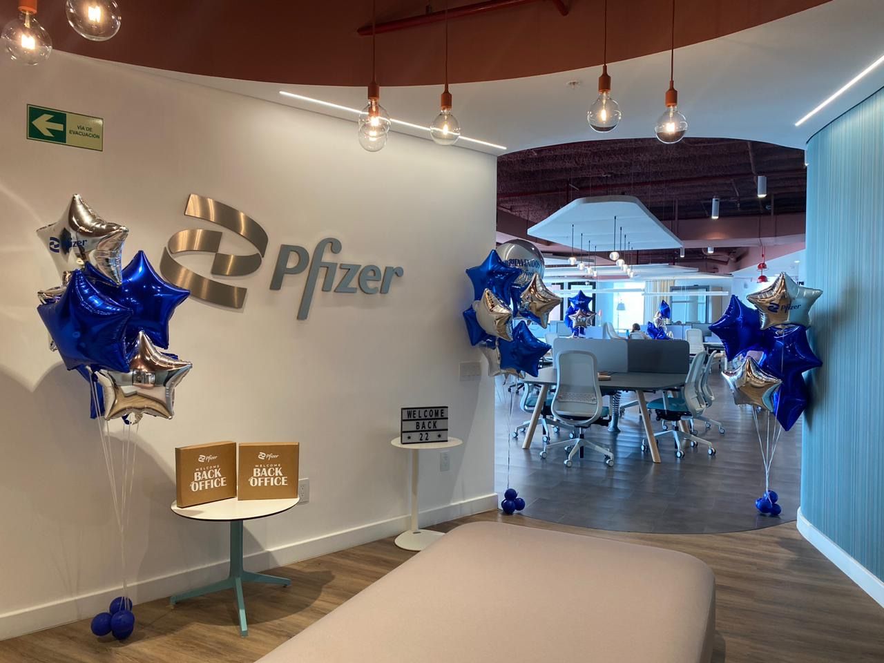 Blue and silver star balloon bouquets decorating an office lobby for a corporate event